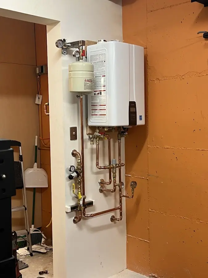 Plumbing technician inspecting water heater connections in Beverly Hills